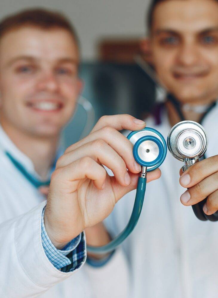 doctors holding stethoscope scaled